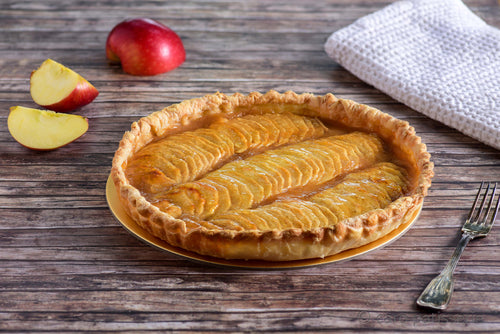 French apple tart with thinly sliced apples and apple sauce