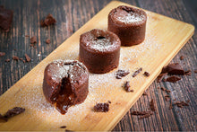 Load image into Gallery viewer, dark chocolate lava cake with melted centre and icing sugar on top
